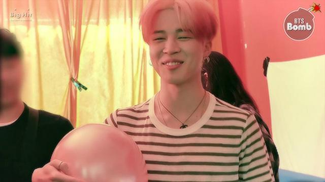 Jimin plays with a balloon